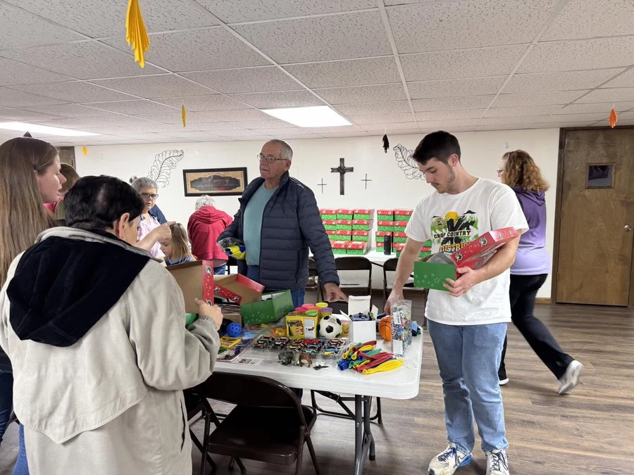 People at First Baptist Church of Polo working together to fill gift boxes.